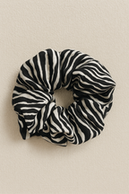 Zebra patterned scrunchie on a beige background