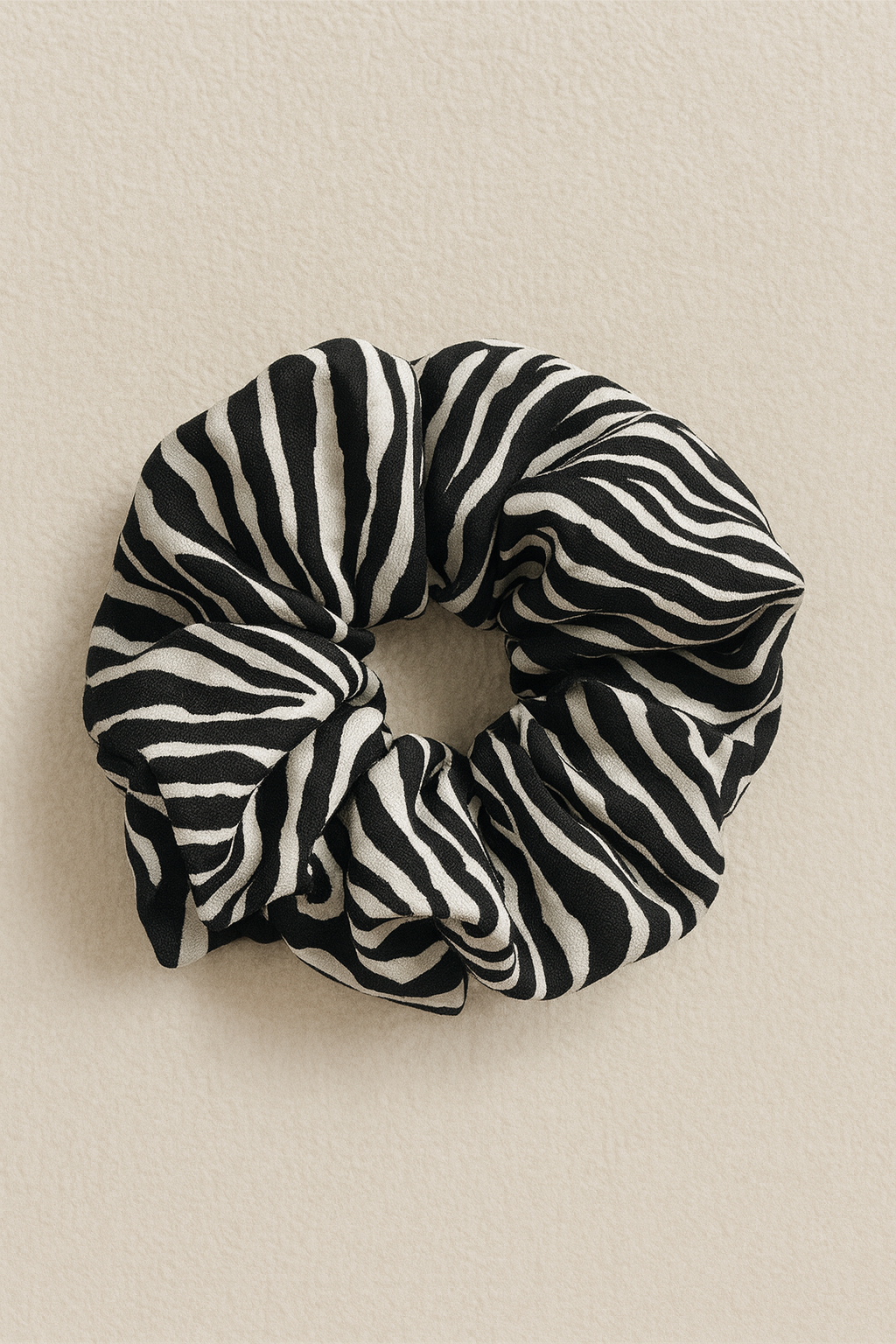 Zebra patterned scrunchie on a beige background